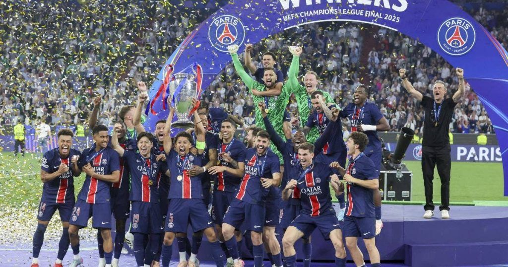 a group of football players celebrating with a trophy