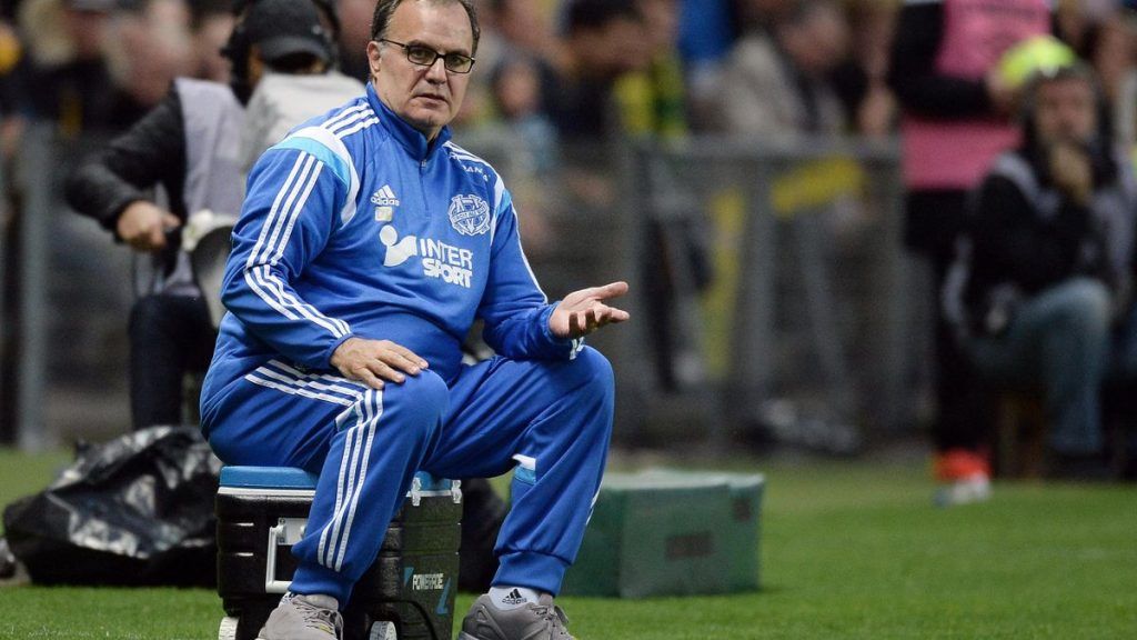 a man sitting on a black cooler